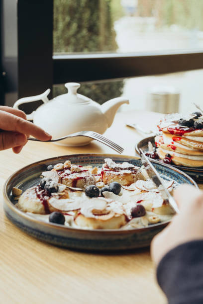 istock A man eats cheesecakes in a cafe for breakfast, a traditional Ukrainian dish. 2174143612