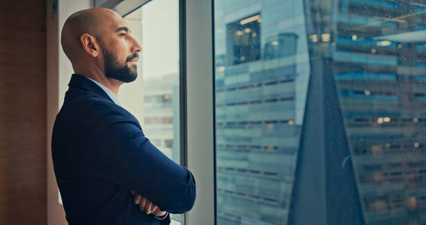 istock Male CEO Looking Out Of Window Thoughtfully. 2174144156