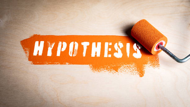 istock Hypothesis Concept. Orange paint and paint roller on wood texture background 2174144895
