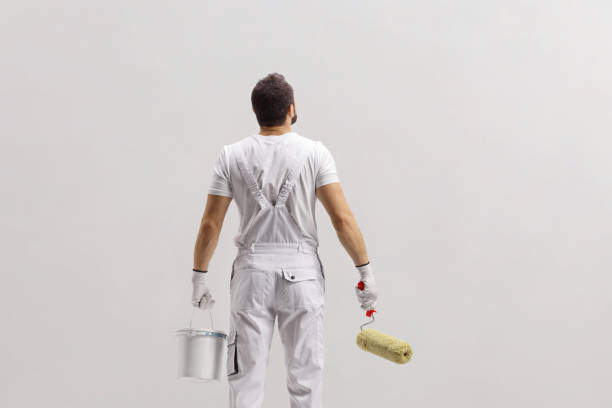 istock Rear view shot of a painter holding a bucket and a paint roller 2174144946
