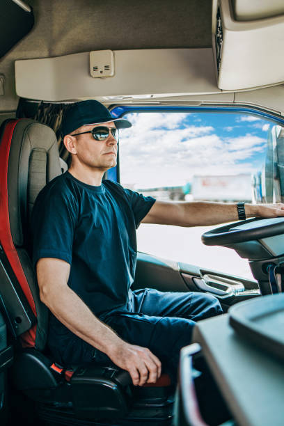 istock Professional truck driver sitting in truck 2174145041