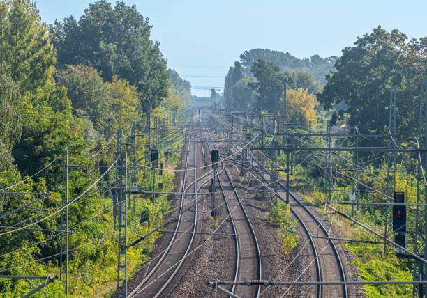 Germany, Berlin, Spandau, September 08, 2024 -Railway tracks in the sunny morning haze