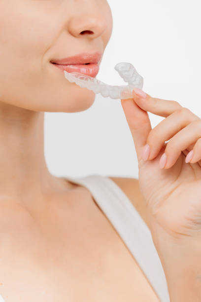 istock A young woman wearing a dental mouthpiece. This comfortable device aids in teeth alignment, enhancing her natural confidence and allowing her to enjoy life without worry. 2174146642