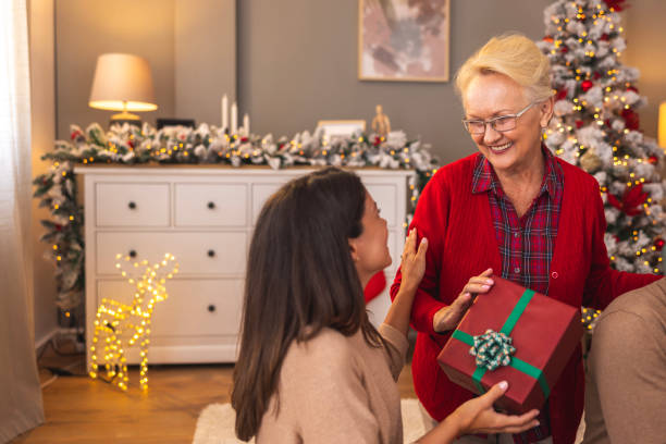 istock Mother and daughter exchanging Christmas presents 2174147538