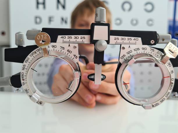 Child using an ophthalmic trial frame for an eye examination in a clinic