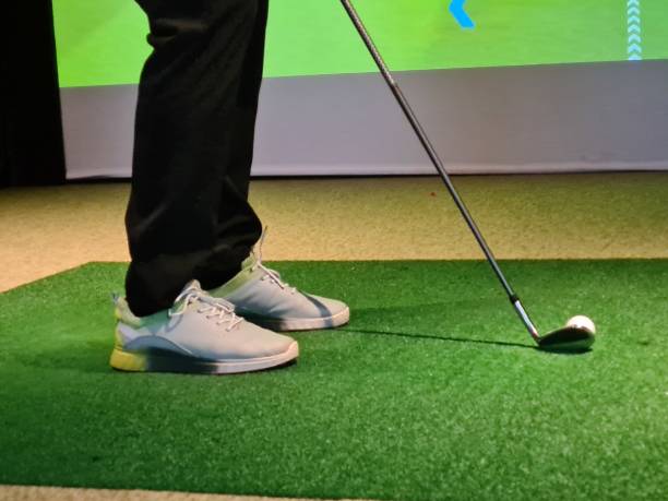 istock Golf swing practice indoors on artificial turf with a focus on the player's grip and stance concept 2174148292