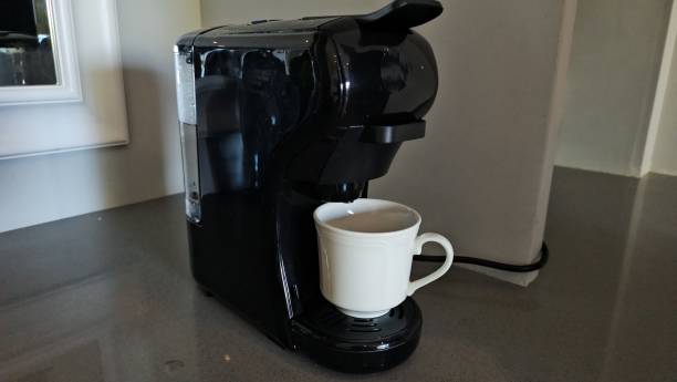 istock Black coffee machine making a cup of hot coffee in a modern kitchen 2174148325