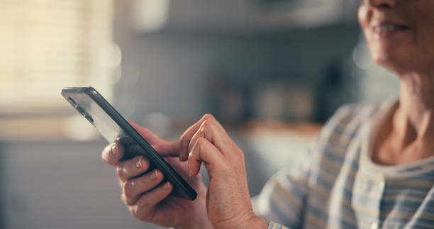 istock happy mature woman using smartphone texting browsing social media reading text messages. 2174149548