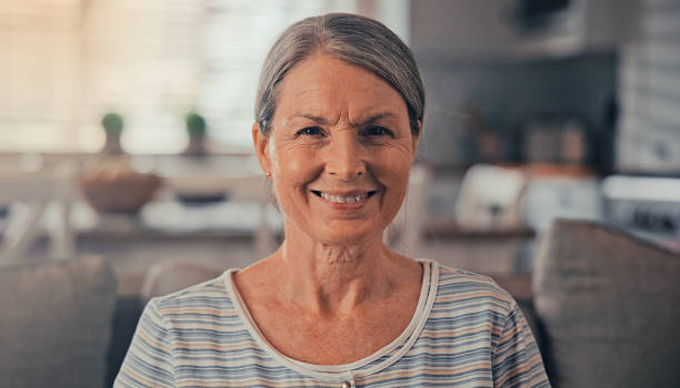 istock Close up face smiling optimistic mature woman pose indoor looking at camera. 2174149760
