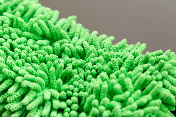 A detailed macro image of a petrol green textured surface, offering a unique and soothing visual. The soft, fleece-like texture adds depth, making it perfect for creative projects, product photography, or digital art