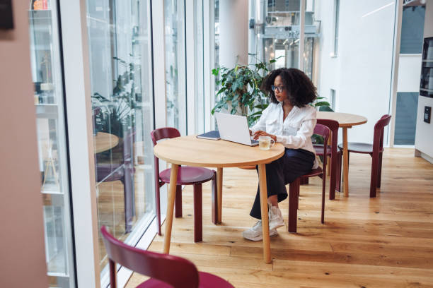 istock Professional Black Woman Working at Laptop in Office Cafe 2174149817