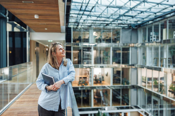 Professional Businesswoman with Folder in Office Corridor