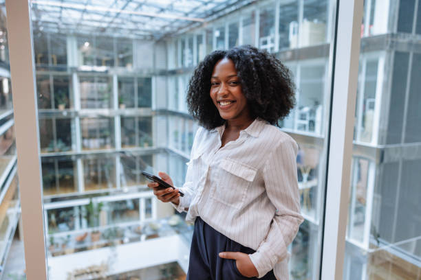 istock Professional Black Businesswoman Using Smartphone in Office 2174150443