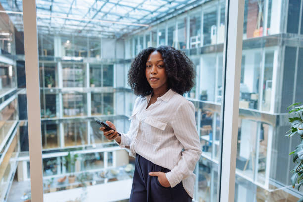istock Professional Black Businesswoman Using Smartphone in Office 2174150454