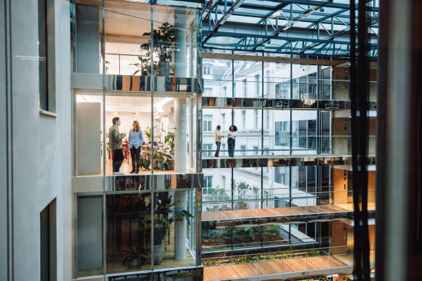 istock Business Meeting in Modern Office Atrium 2174150484