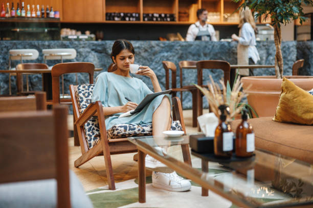 istock Professional Indian Woman Jotting Down Notes in Cafe 2174150496