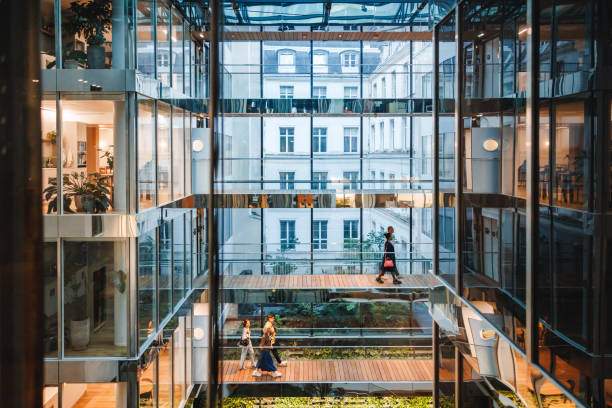 istock Diverse Professionals Navigate Glass-Enclosed Office Space 2174150543