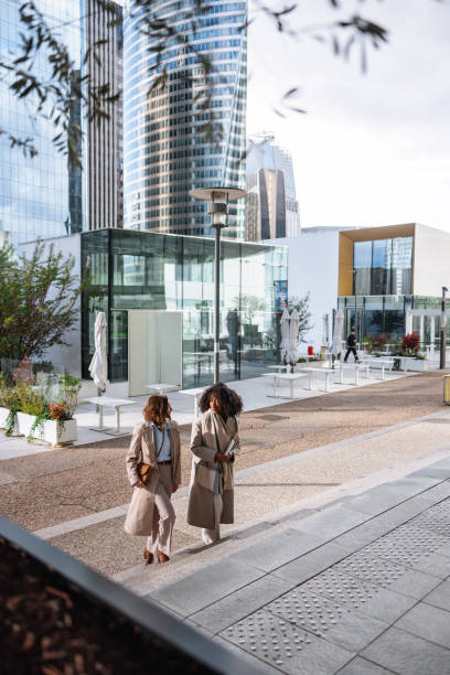 istock Two Female Business Executives Walking Together Happily 2174152423