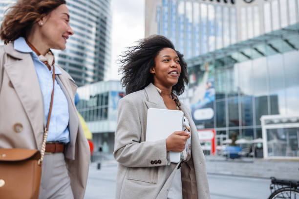 istock Mature Caucasian And Young Black Female Executives Commuting Energetically 2174152506