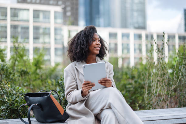 Cheerful Young Black Businesswoman Using Digital Tablet Outside