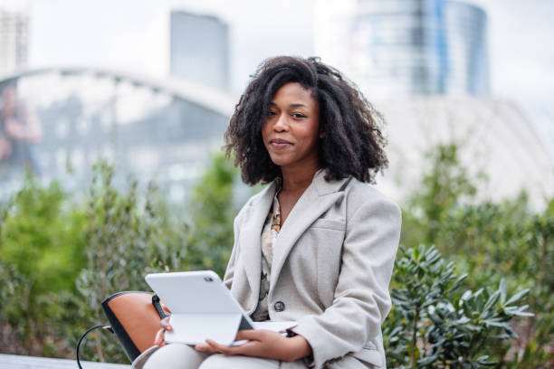 istock Cheerful Young Black Businesswoman Using Tablet Outside Office 2174152657
