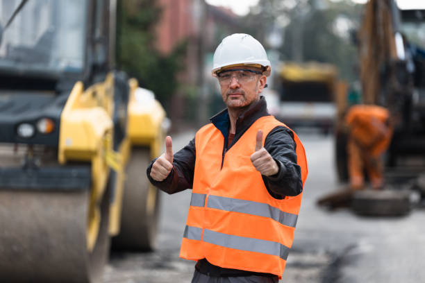 istock Construction worker giving thumbs up on a busy road site during daylight in an urban setting 2174155576
