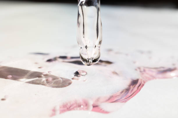 Pipette with essential oil on bottle blurred background