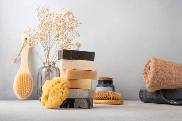 Stack of handcrafted soap bars and natural sponge