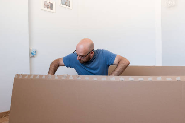 istock The man assembling new furniture in his house 2174162413