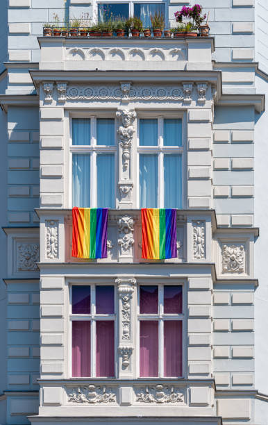 istock Rainbow flags on the window of an old residential building 2174162984