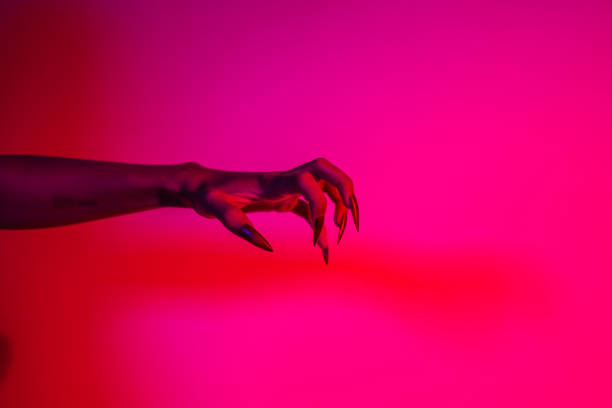 istock A terrifying witch's hand with long red nails, resembling a demon or vampire. Its gnarled appearance hints at monstrous origins, resembling an alien or ghostly entity,with zombie-like decayed skin. 2174164467