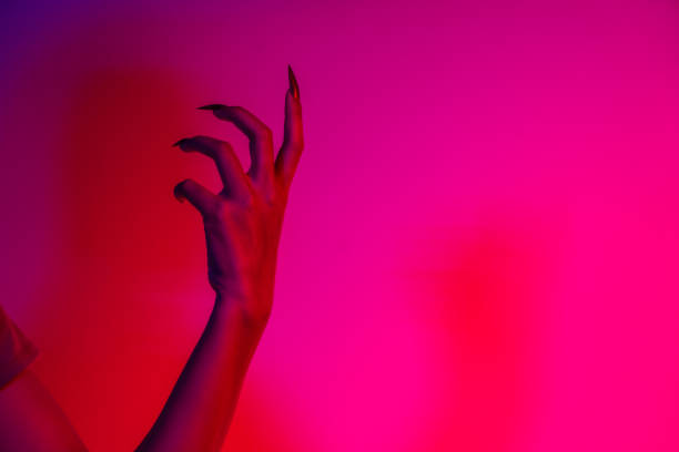 istock A terrifying witch's hand with long red nails, resembling a demon or vampire. Its gnarled appearance hints at monstrous origins, resembling an alien or ghostly entity,with zombie-like decayed skin. 2174164491
