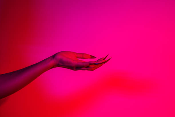 istock A terrifying witch's hand with long red nails, resembling a demon or vampire. Its gnarled appearance hints at monstrous origins, resembling an alien or ghostly entity,with zombie-like decayed skin. 2174164503