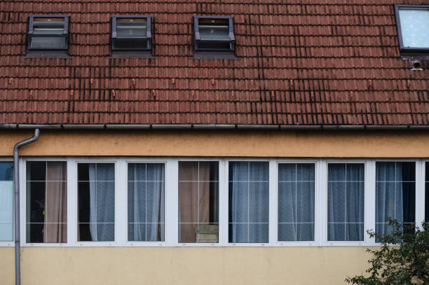 istock Residential building facade with windows and red roof 2174164916