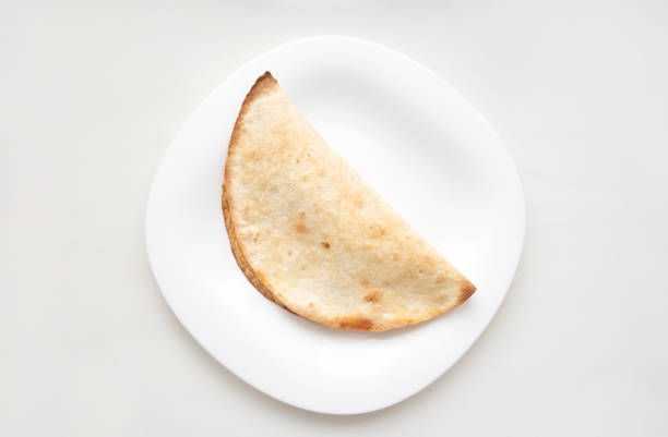 istock Minimalist composition of a simple taco on a white plate high key lighting 2174165823