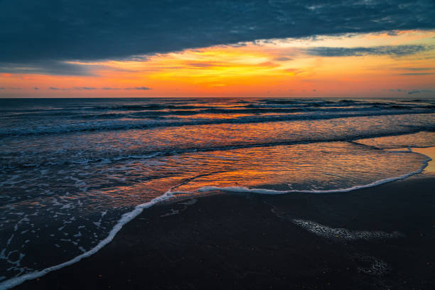 Colorful sunrise on the sea sandy beach