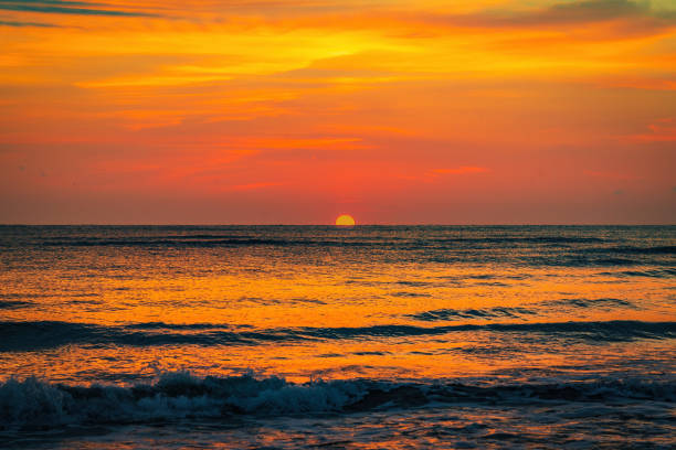 Colorful sunrise on the sea sandy beach