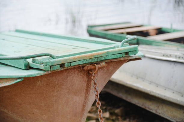 old wooden rowing boats in row on river bank