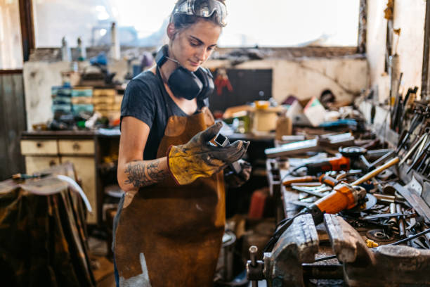 istock Young Woman Working On A Thin Metal Rod In A Workshop 2174169531