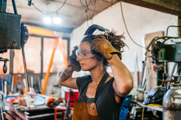 istock Young Woman Putting On Protective Earwear Before Working On A Drill Press In A Metal Workshop 2174169940