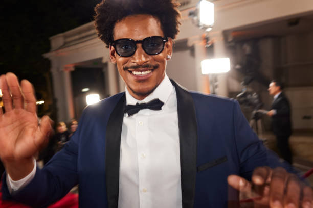 istock The actor smiles while using his hands to protect himself from the paparazzi on the red carpet 2174170057