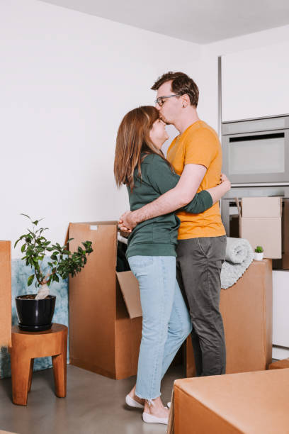 istock Happy Couple Embracing During Moving Day 2174172540