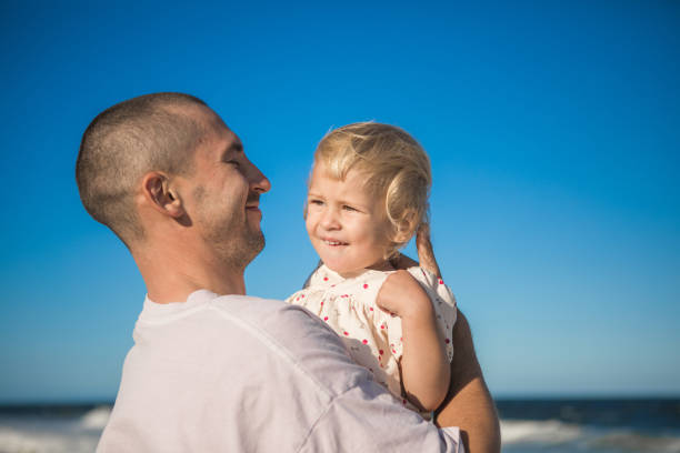 Delighted father spending fun time with his little daughter