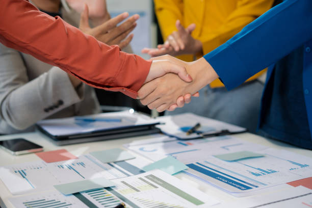 istock Close up business people holding each others wrists, join hands together, support and unity, team strength and power, colleagues involved in team building activity. 2174177162
