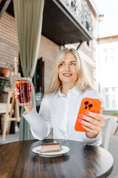istock young woman sits in cafe 2174177257