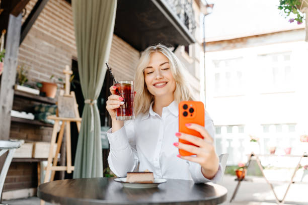 istock young woman sits in cafe 2174177266