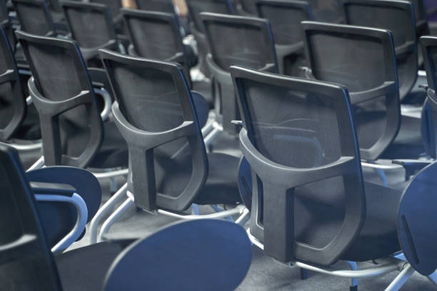 istock Empty conference room with rows of modern black office chairs arranged 2174181519