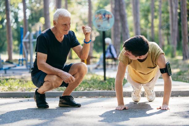 istock Elderly man encourages young man during a workout 2174183572
