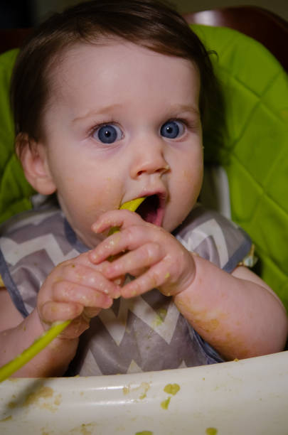 istock Baby Girl Eating 2174183579