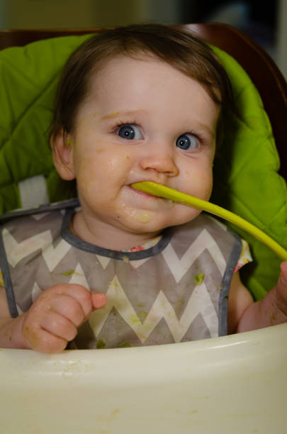 istock Baby Girl Eating 2174183598